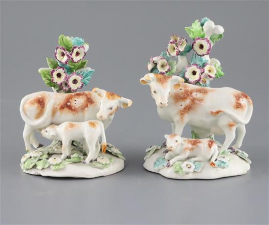 A near pair of Derby groups of a cow and calf, c.1760-5, H. 11 and 12.7cm
